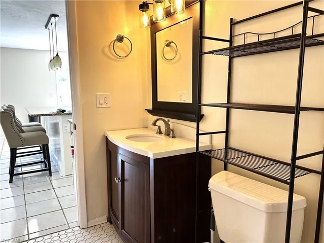 Bathroom in 1/1 side featuring tile flooring, vanity, and toilet