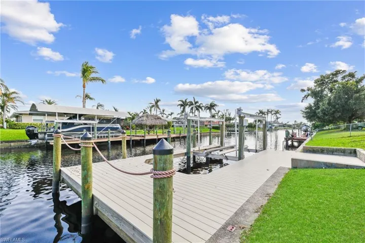 New Dock with a canal water view and a lawn