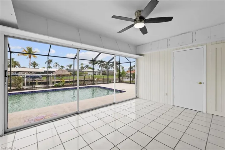 3/3 Side: Outdoor pool featuring a ceiling fan, a screened lanai, and a patio area