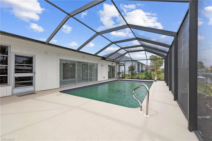 Outdoor pool featuring a screened lanai