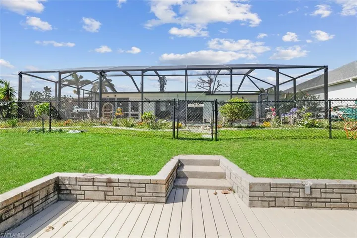Newer dock featuring a fenced backyard and new screened pool cage.