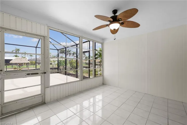1/1 Side: Sunroom with ceiling fan and plenty of natural light