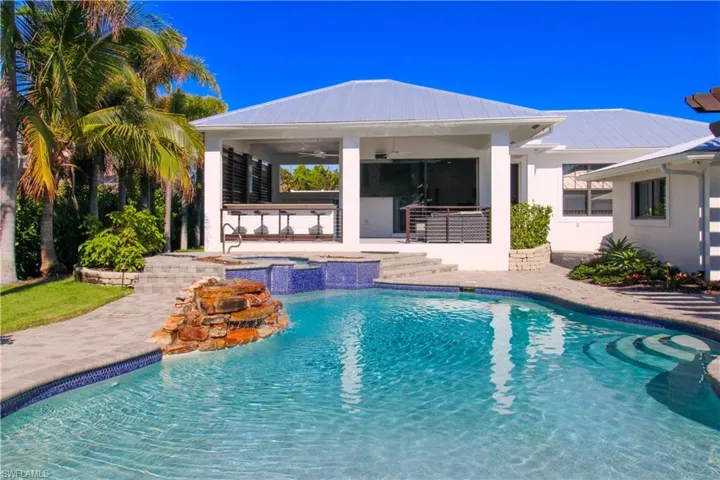View of swimming pool with a gazebo, a patio, an outdoor bar, and ceiling fan