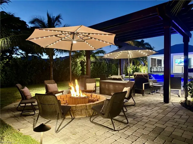 View of patio featuring an outdoor living space with a fire pit