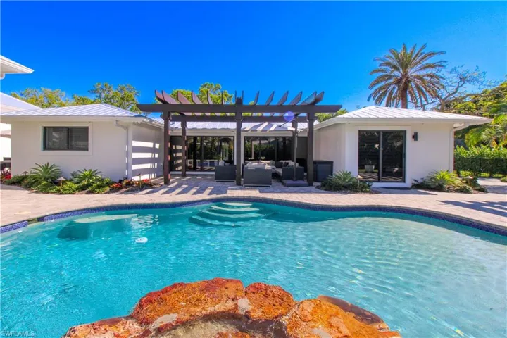 View of pool with a pergola, an outdoor living space, and a patio