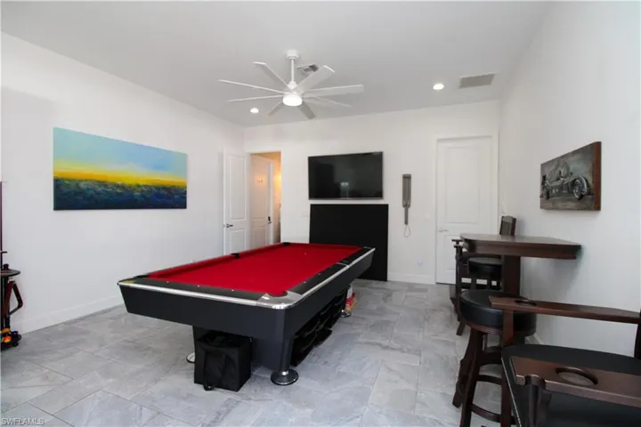 Playroom with ceiling fan and billiards