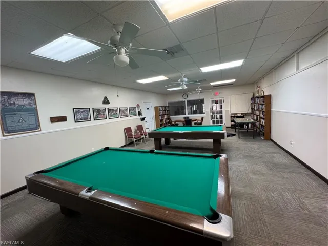Recreation room featuring a ceiling fan, pool table, and a paneled ceiling