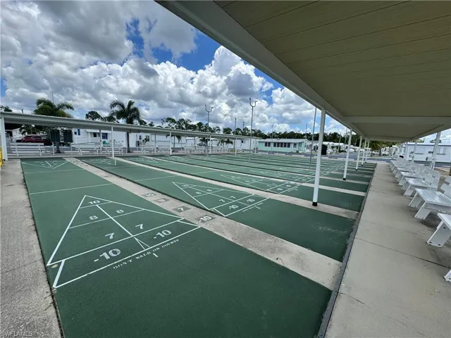 View of property's community featuring shuffleboard