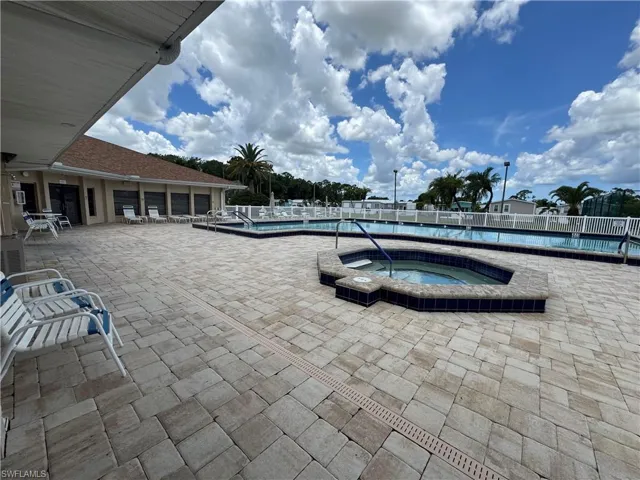 Community pool featuring a patio area and a community hot tub