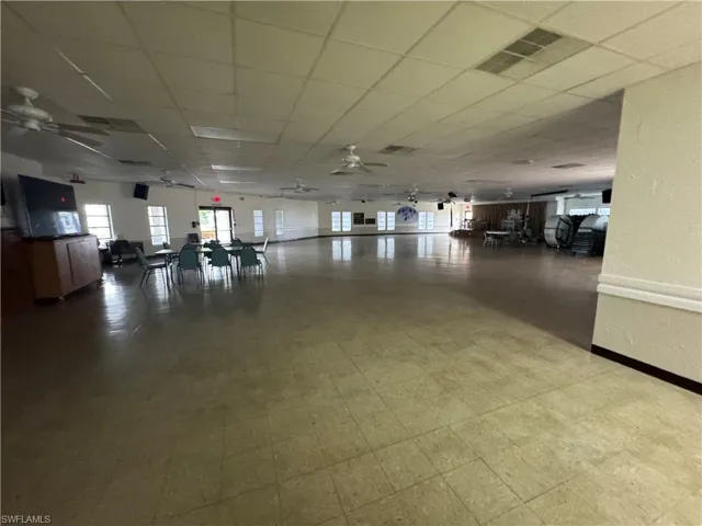 Misc room with a paneled ceiling and a ceiling fan