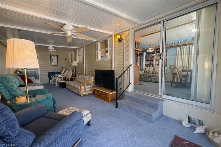 Sunroom / solarium featuring a patio, outdoor lounge area, a ceiling fan, and beamed ceiling