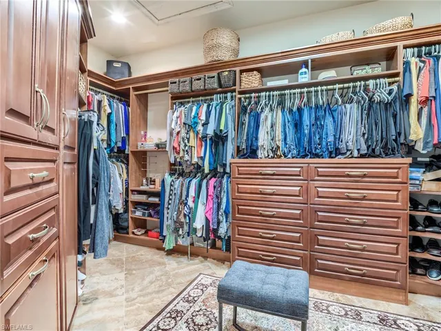 Spacious closet with light tile patterned floors