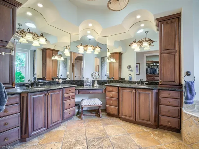 Bathroom with tile patterned floors and dual bowl vanity
