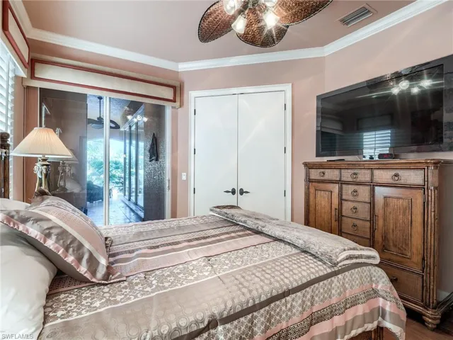 Bedroom featuring access to outside, ornamental molding, a closet, and ceiling fan
