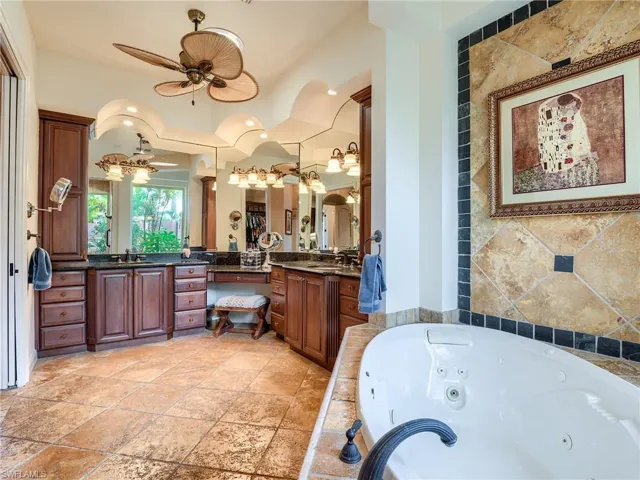 Bathroom featuring ceiling fan, vanity, and tile patterned flooring