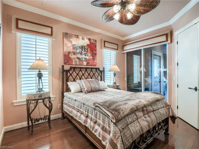 Bedroom with ceiling fan, crown molding, access to outside, and dark hardwood / wood-style floors