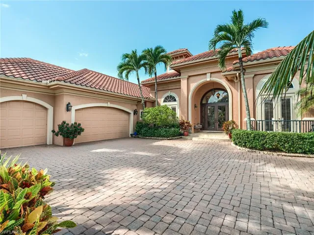 Mediterranean / spanish-style house with a garage and french doors