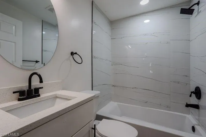 Full bathroom featuring bathing tub / shower combination and vanity