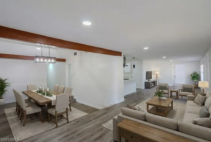 Living area featuring recessed lighting, wood finished floors, and beamed ceiling
