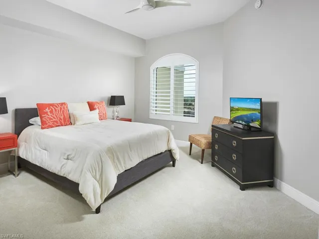 Carpeted bedroom with ceiling fan