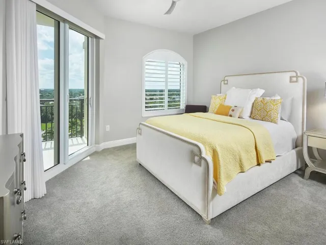 Carpeted bedroom with access to exterior, multiple windows, and ceiling fan