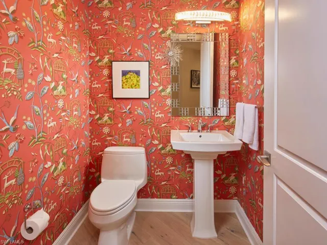 Bathroom with hardwood / wood-style floors and toilet