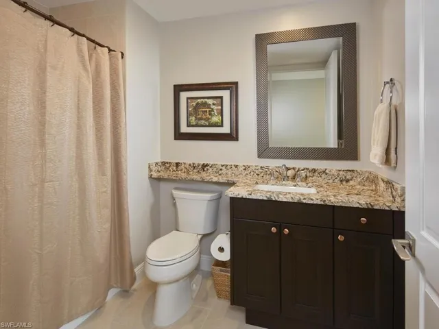 Bathroom with tile patterned flooring, vanity, and toilet