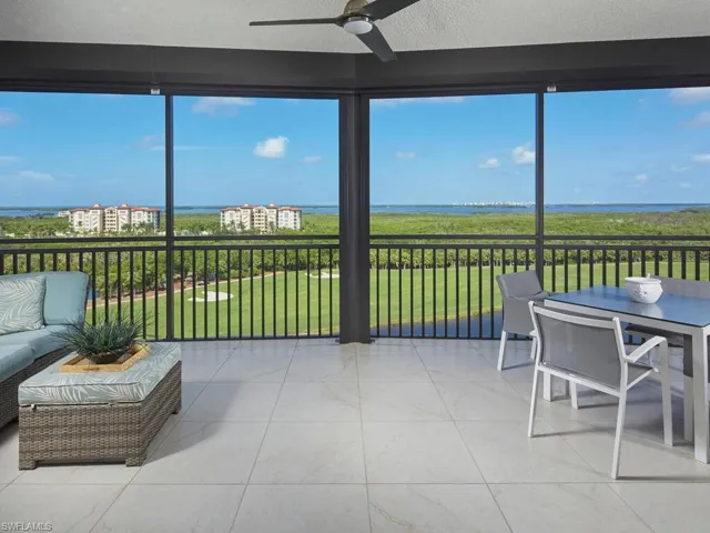 Sunroom with a water view and ceiling fan