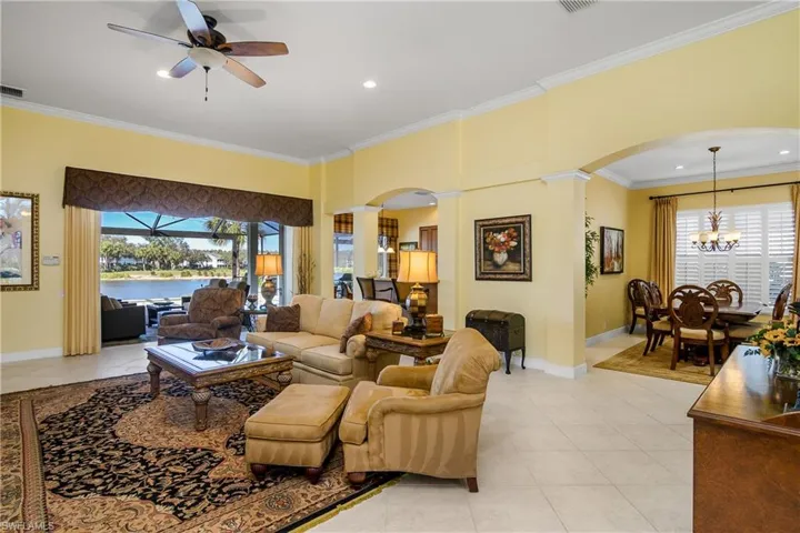 Great room architecture, ceramic tile flooring laid on diagonal, sliding glass doors pocket with lanai view, dining room to right