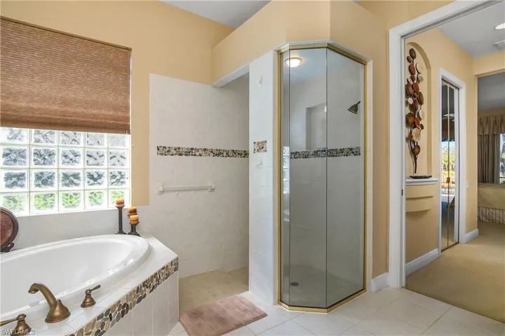 Master bath: tub, walk-in shower and master bedroom to right