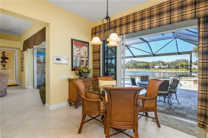 Kitchen / breakfast area with sliders to lanai and lake view. Walls in this house can be opened for outdoor living.