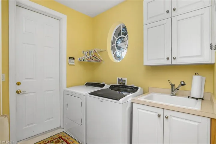 Utility room, plenty of storage space, sink, window view to front entry, door leads to 2 car garage. Water heater powered by natural gas, located in garage.
