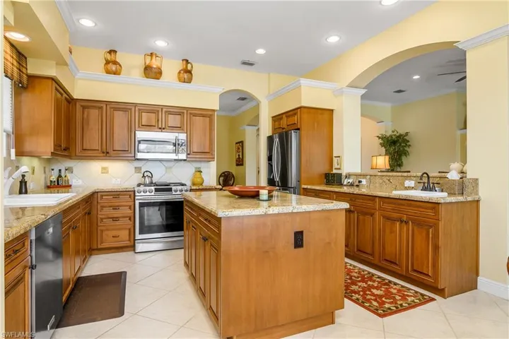 Kitchen, arch entry to dining room, great room to right