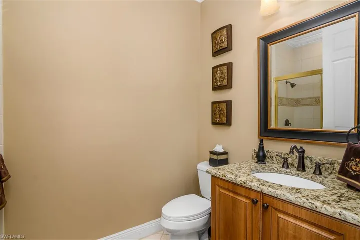 Full bath adjacent to 4th bedroom / office, has a walk-in shower (see mirror). Granite counters.