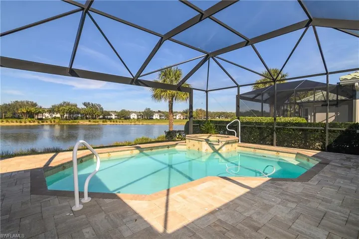 Steps leading to shallow end of pool, spa beyond. Pool and spa can be operated and heated independently.