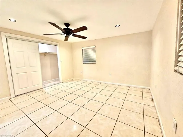 Unfurnished bedroom featuring a closet, ceiling fan, light tile patterned floors, and recessed lighting