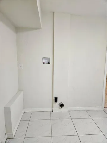 Laundry room featuring hookup for a washing machine and light marble finish floors