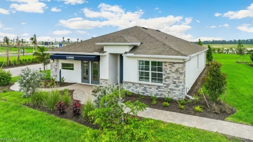 Model Home - Contemporary single-story residence featuring a neutral stucco exterior with decorative stone accents