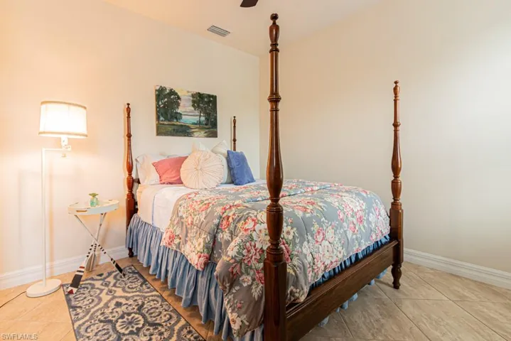 Bedroom featuring light tile patterned floors and a ceiling fan