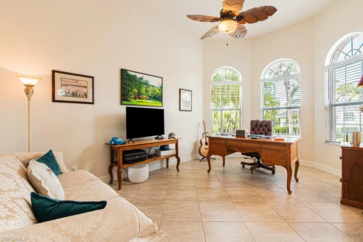 Office area featuring a ceiling fan and light tile patterned floors