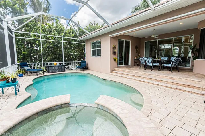 View of pool featuring and connected spa, a patio area, and a ceiling fan