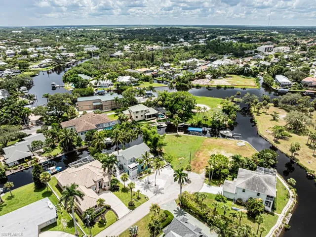 Aerial perspective of suburban area with a nearby body of water