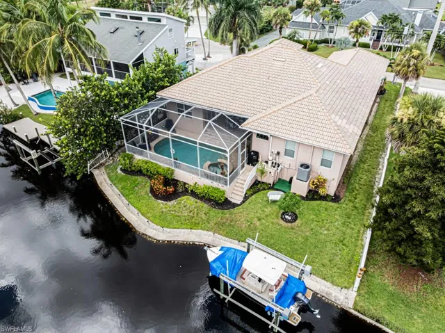 Drone / aerial view of a pool and a large body of water