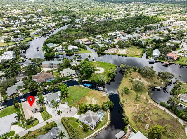 Aerial overview of property's location with a nearby body of water and nearby suburban area