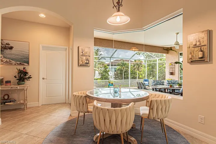 Dining space featuring a sunroom and light tile patterned floors