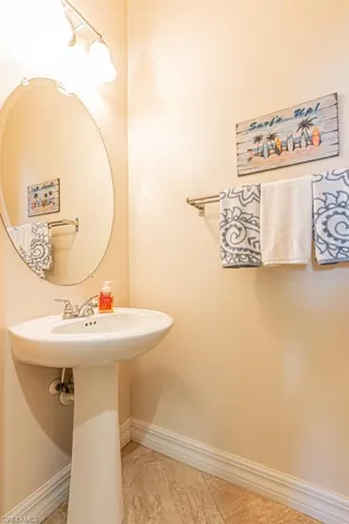 Bathroom featuring baseboards and light tile patterned flooring