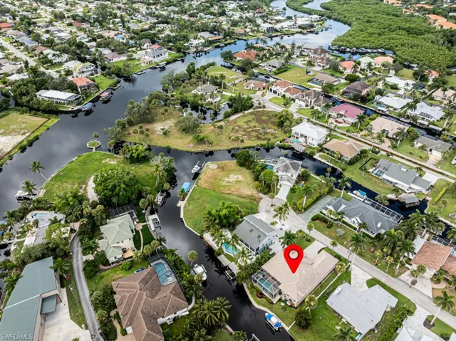 Aerial view of property's location with nearby suburban area and a large body of water