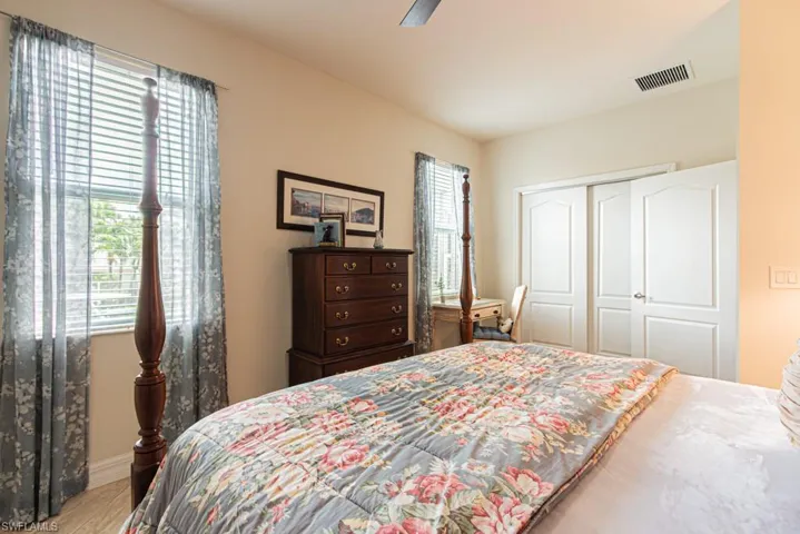 Bedroom with a closet, a ceiling fan, and light wood-style flooring