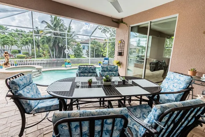 Sunroom / solarium with a patio, outdoor dining area, and a spa