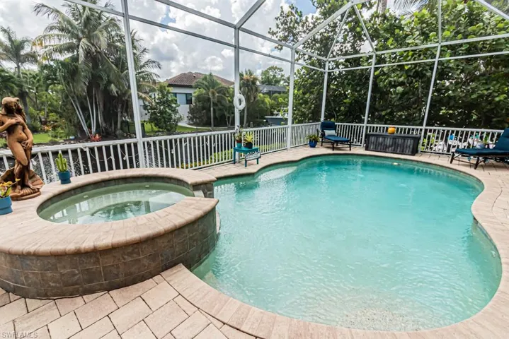 View of pool and spa with a lanai and sunroom